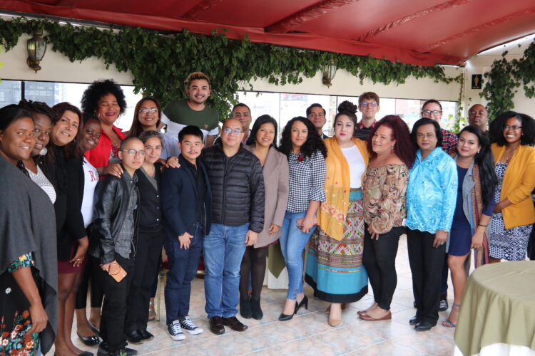 Trans activists from LAC and AP regions standing in a group smiling and looking at the camera