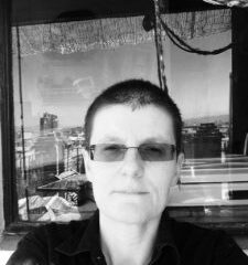 Monochrome photo of of Amets Suess wearing sunglasses and looking directly into the camera