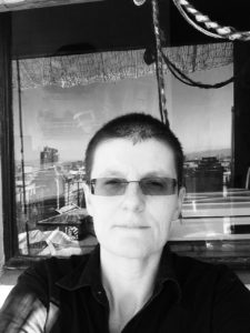 Monochrome photo of of Amets Suess wearing sunglasses and looking directly into the camera